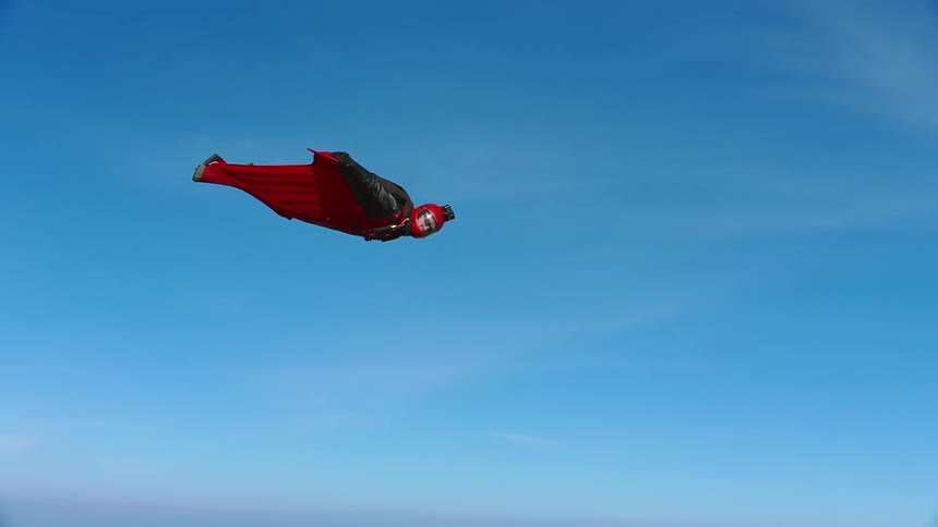 A man is flying with a wingsuit
