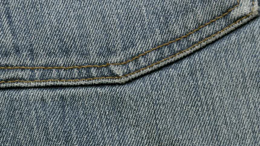 Extreme closeup of the seam of a pair of jeans