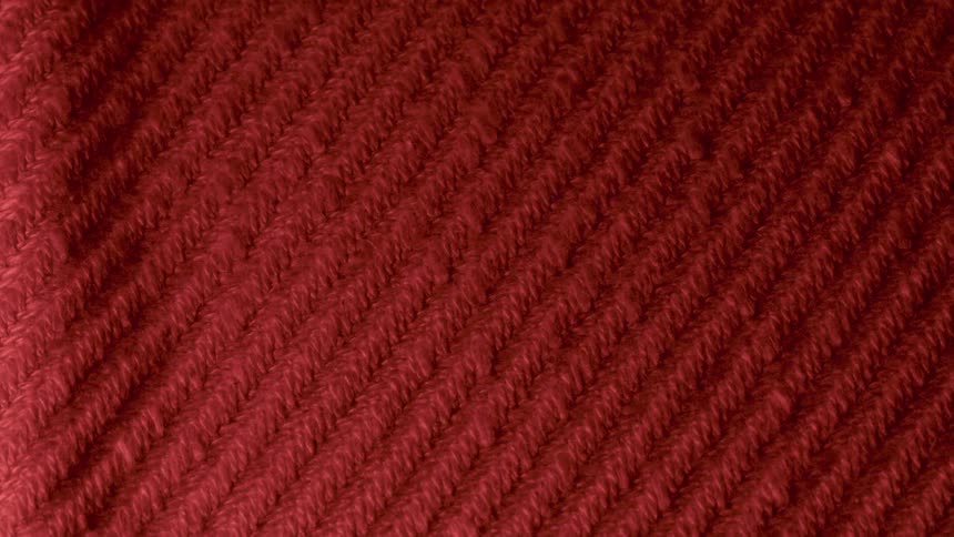 A fabric surface with red color patterns with a light passing through