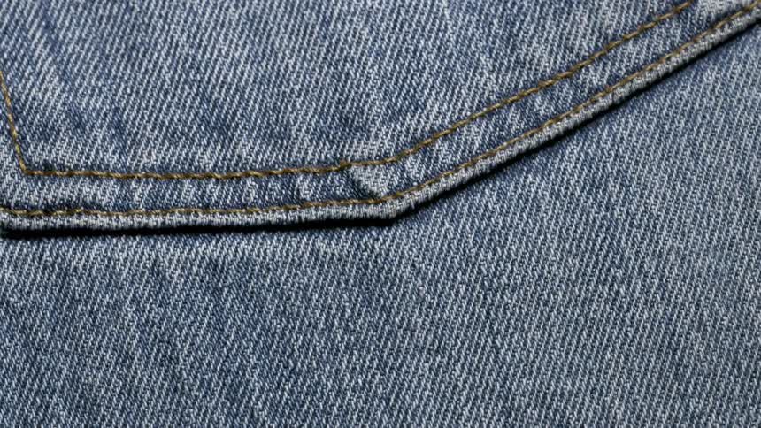 Closeup of light blue jeans with stitching