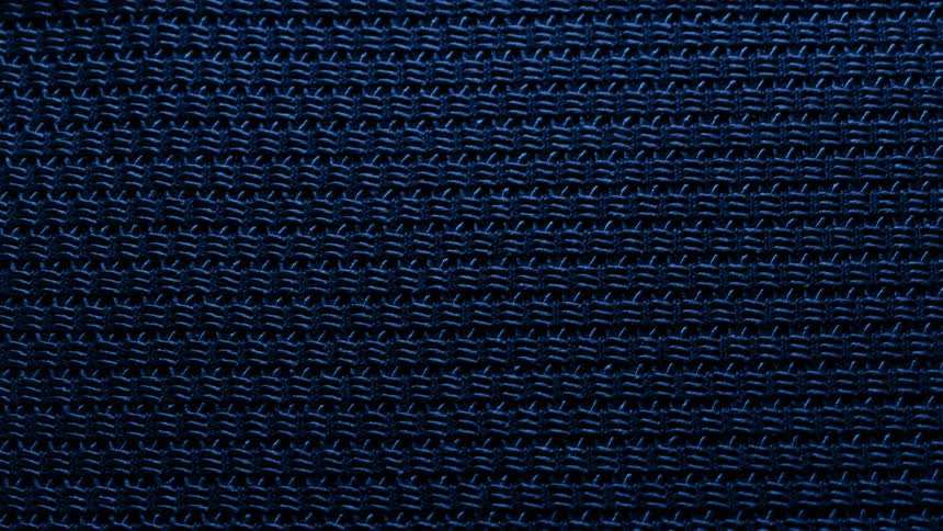 A blue fabric with rough surface is visible as the light flicks