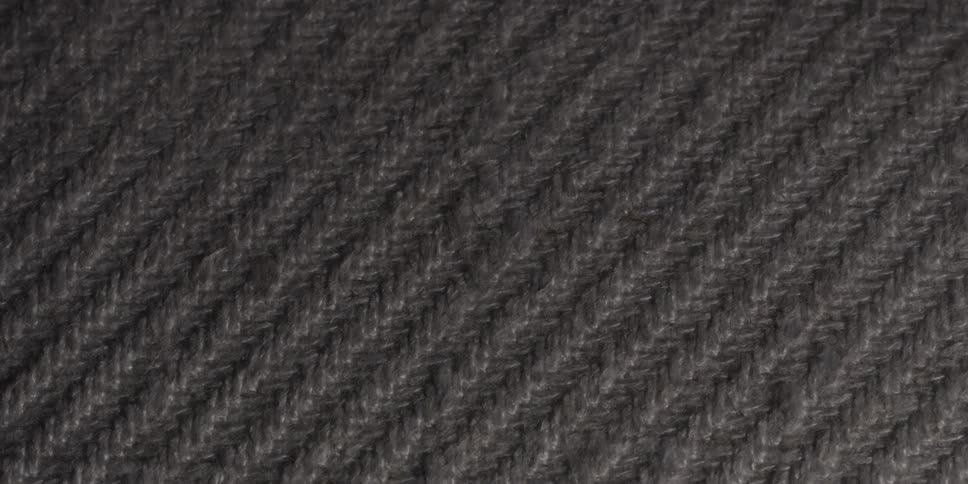 A patterned rope full of fibers and with lighting passing through its texture
