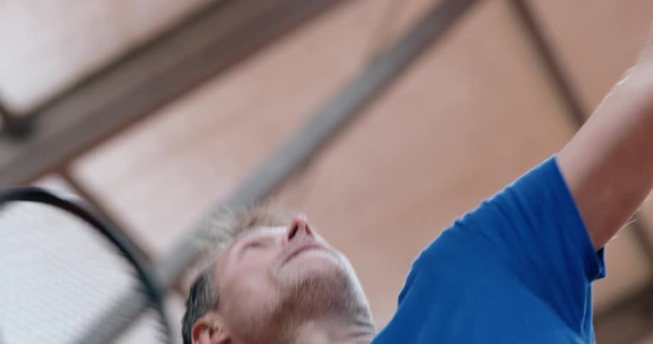 Man serves tennis ball