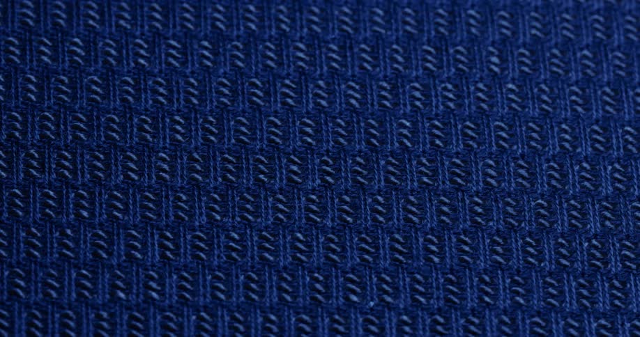 A fabric surface with blue color patterns is rotating