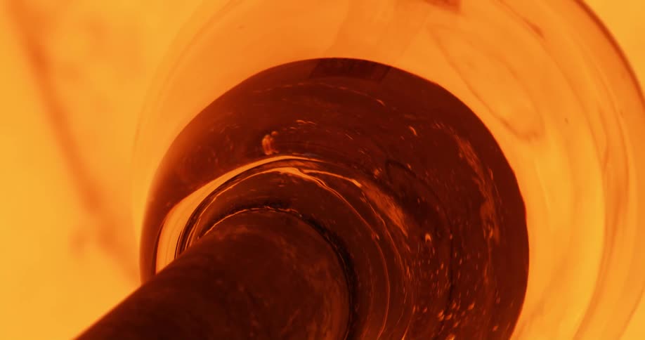 A closeup of a welding machine fabricating the mold of a glass vase