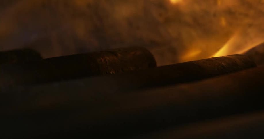Yellow flames rise inside an oven or furnace