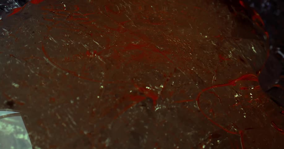 A extreme closeup of a red glass cooling down from the heat