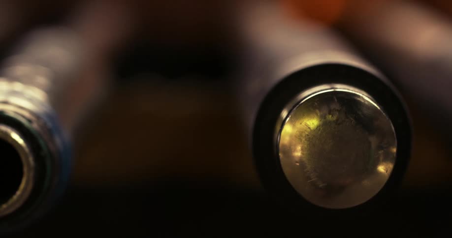 Colored glass at the tip of a rod next to a furnace