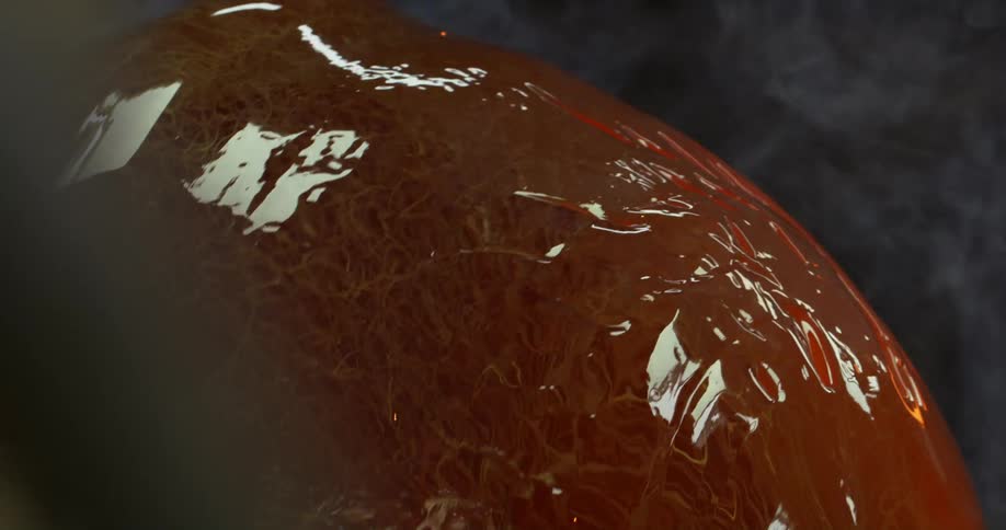 The reflective object spins in the smoke