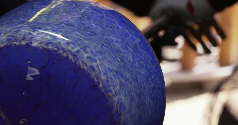 A worker is spinning glass