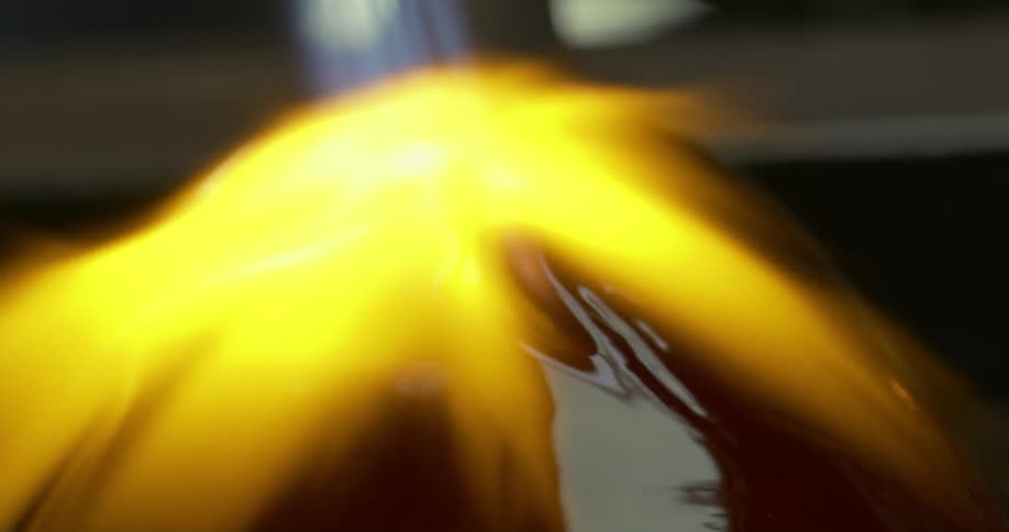 View of a crystal vase being welded by a torch