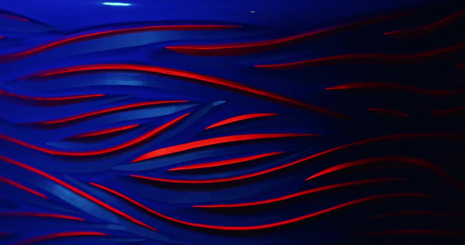 An object with patterns of blue and red color lines is being lit and dimmed