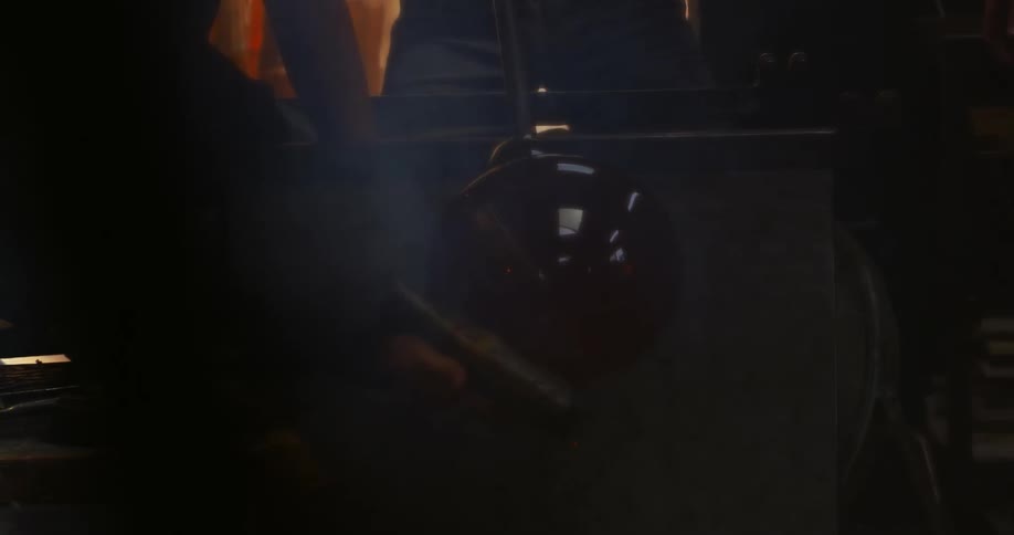 A hand sanding a glass vase in its solid manufacturing state