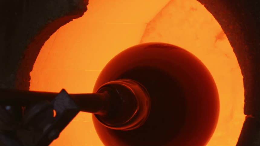 Hot glassware at the tip of a blowpipe taken out of a hot oven