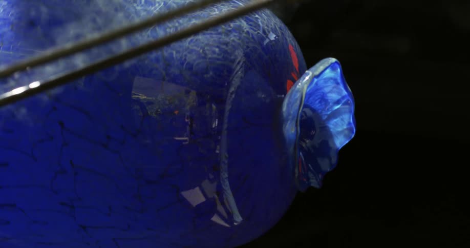 Finishing a blue glass vase