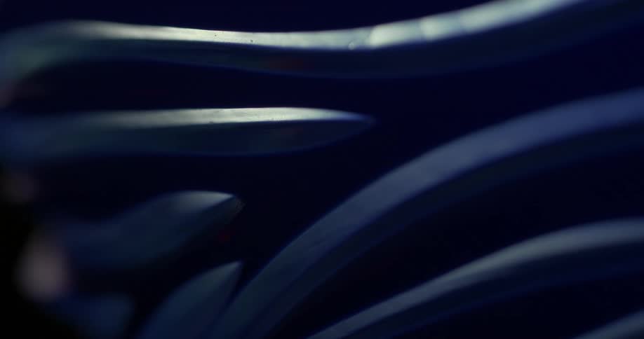A blue object with sharp edges is being illuminated by a light