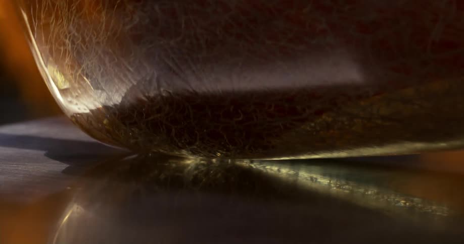 Glass is rolled through flames and across a reflective surface during glass production