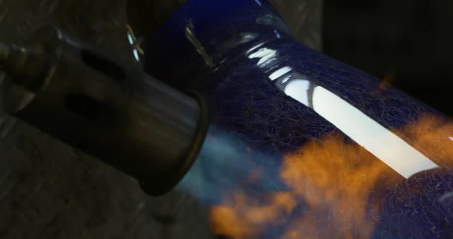 A flame going against a blue vase