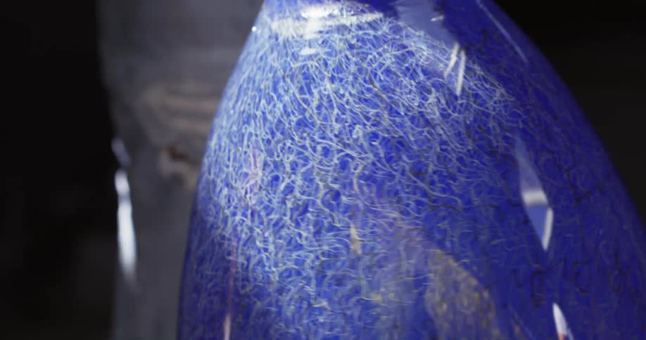 A large blue glass rotates showing the reflection of its surroundings