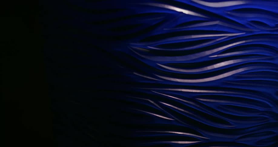 Lights and shadows run over a blue stripped surface