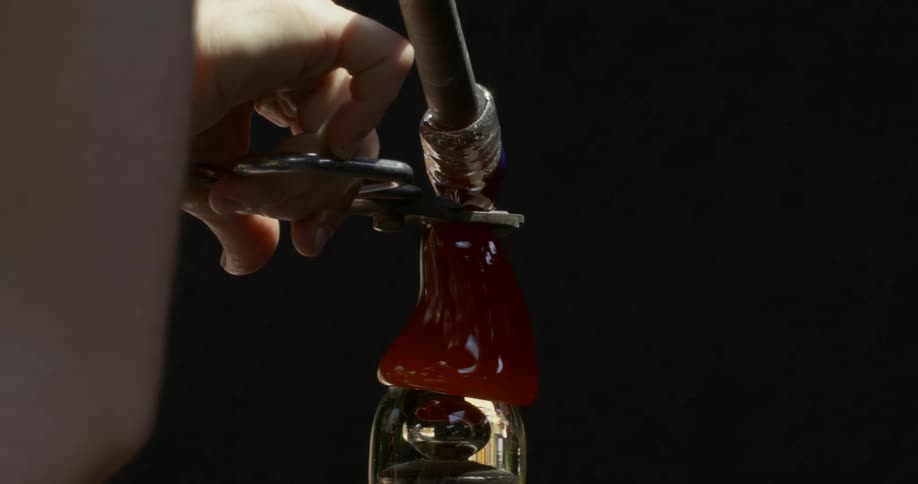 Closeup of a persons hands cutting liquid glass