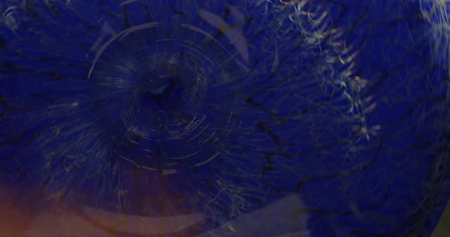 A purple wheel turns while a flame is being introduced to it from the side