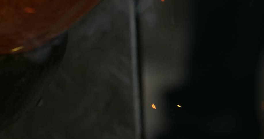 A glass material being manufactured that is rotating and giving no sparks