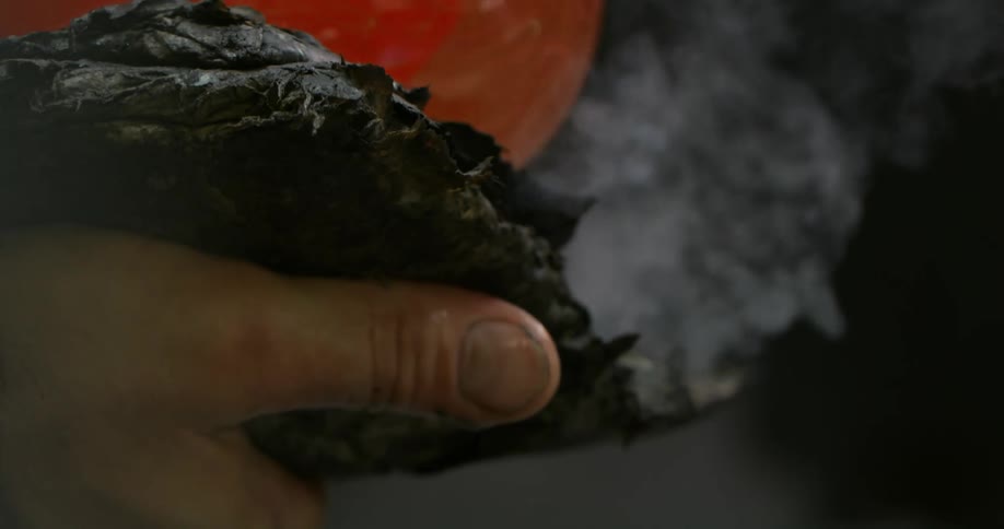 A person is spinning glass with a rag