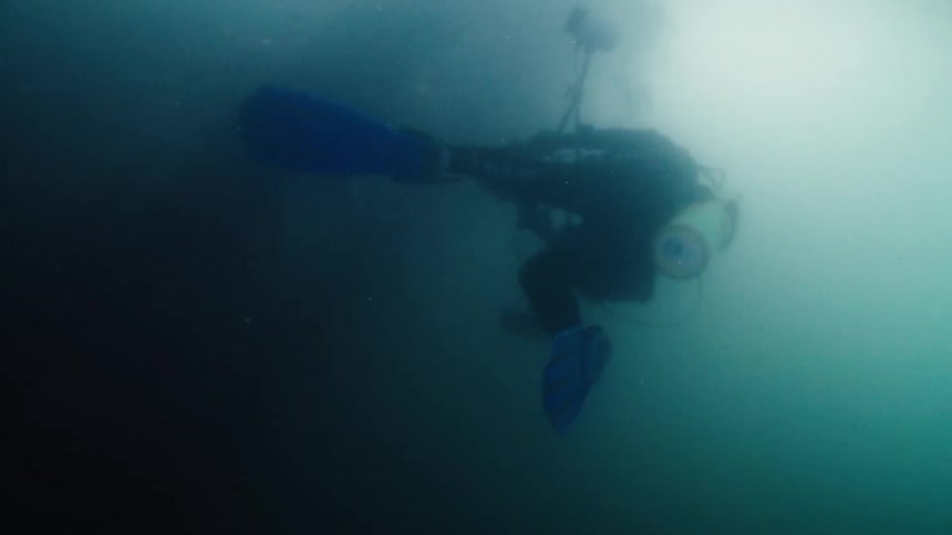 A scuba diver is filming underwater