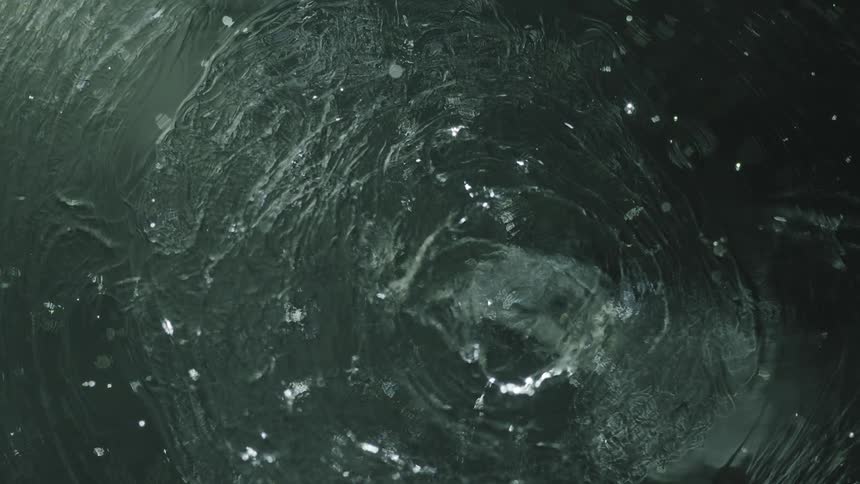 Aerial of water drops on the ocean at midday