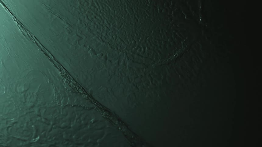 Close up of the dark green water texture flowing