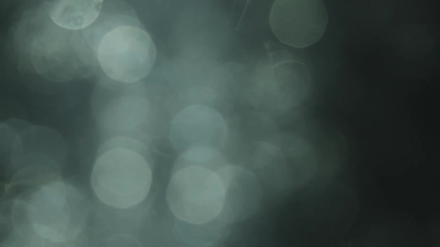Blurry spots float across each against gray background