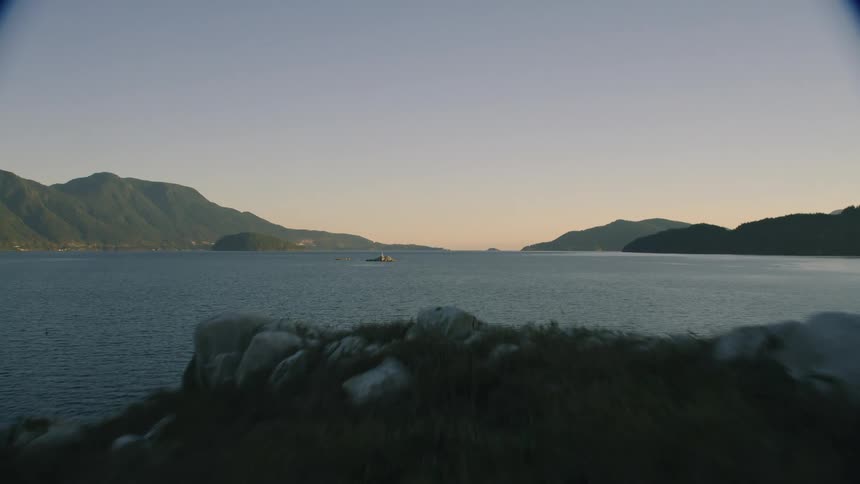 View of the sea with a small rocky island in the center