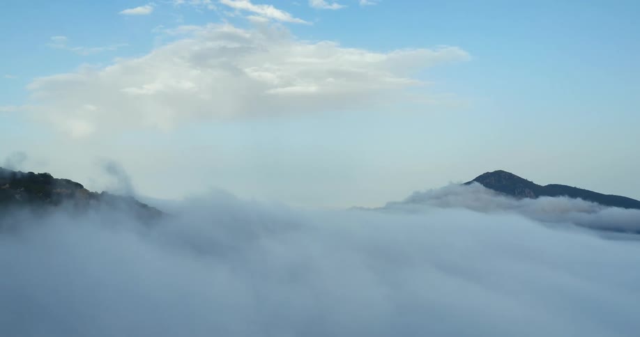 Aerial view of clouds shrouding mountains