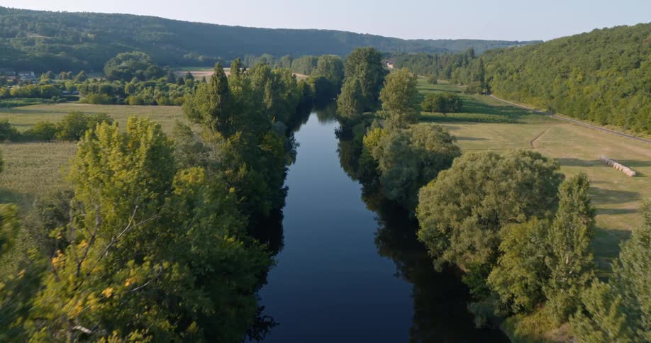 Aerial view of a river winding through trees plains and a natural environment
