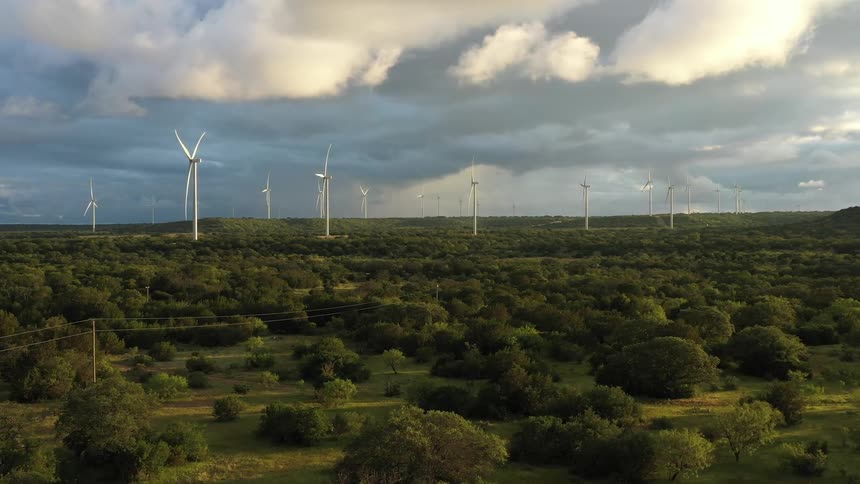 Wind turbines on a field at midday moving clockwise