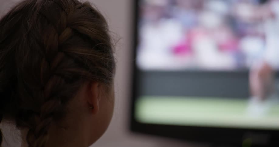 A child is watching tennis on television