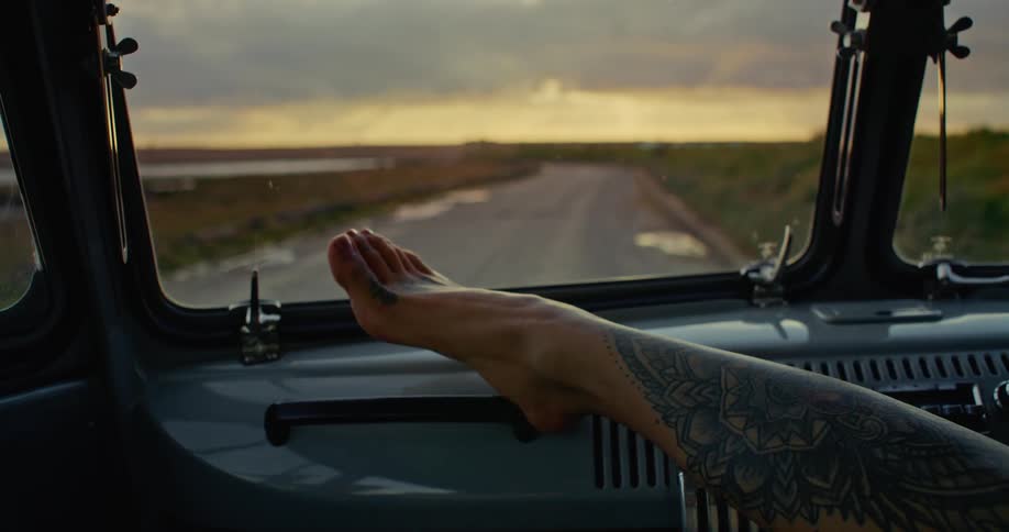 A person puts their feet on the dash