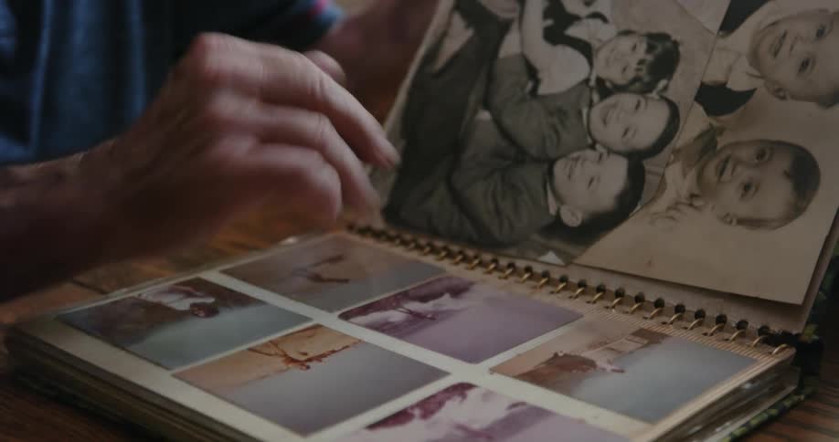 A man looks at photos in the album