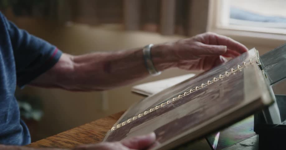 A man is flipping through a photo album