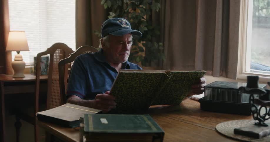 A man is looking through a photo album
