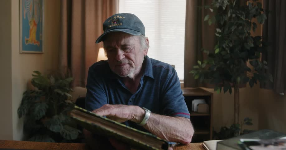 A man beings looking through a photo album