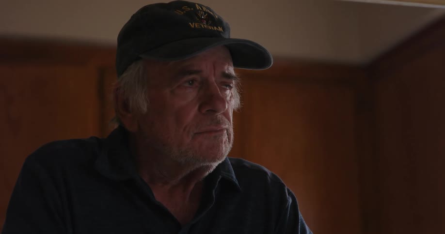 Man stands pensively at home thinking of old memories