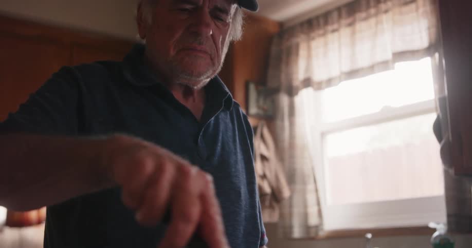 A man is stirring a pot at home