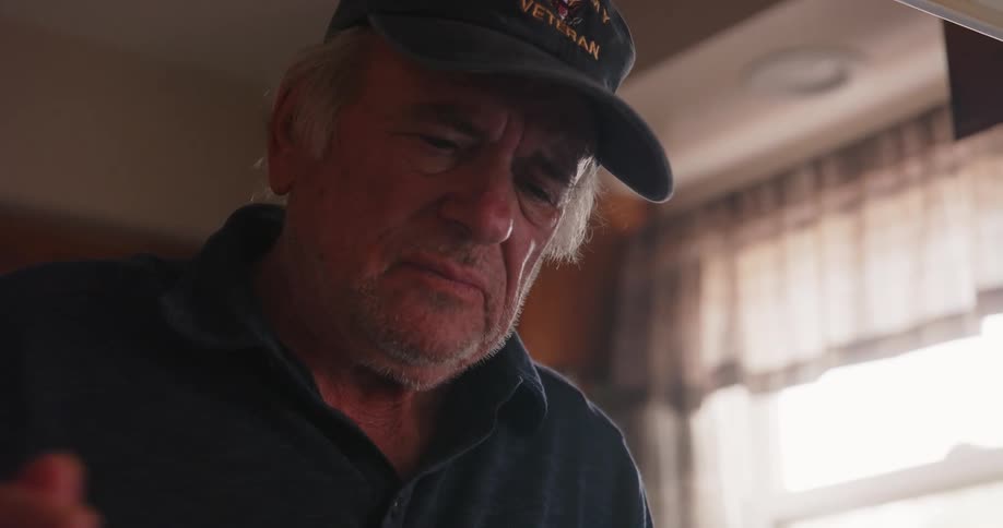 A man looks around and leans forward