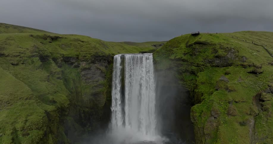 The waterfall runs off the tall mountain