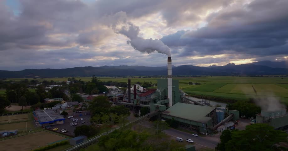 A factory sits by the farm land