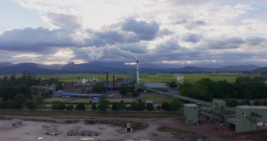 Aerial of a factory in a rural town during dusk