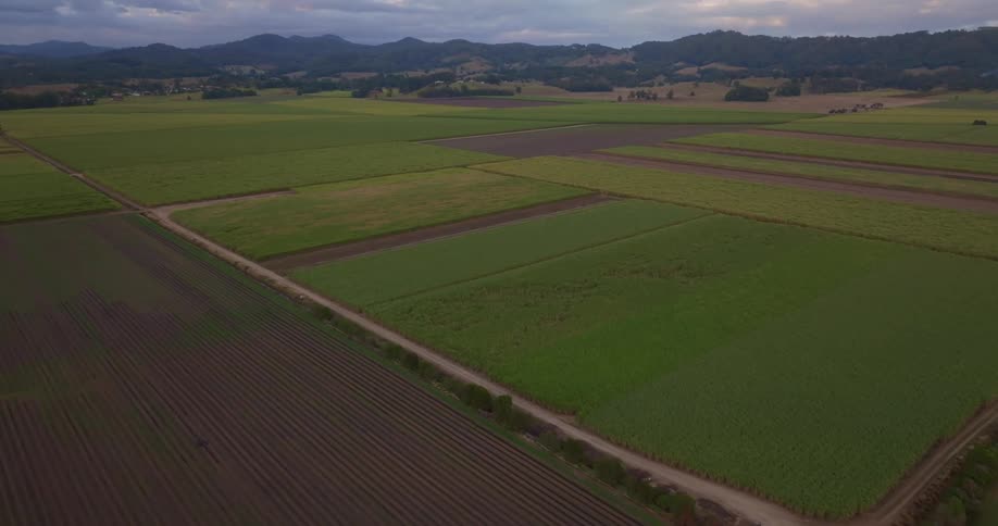 Aerial view of a rural area with a mountain range in the distance