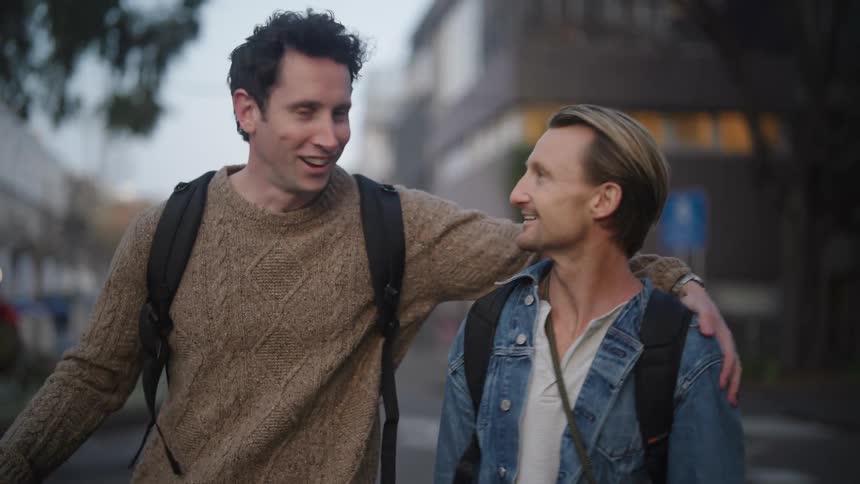 Two happy men walking on the streets of a neighborhood